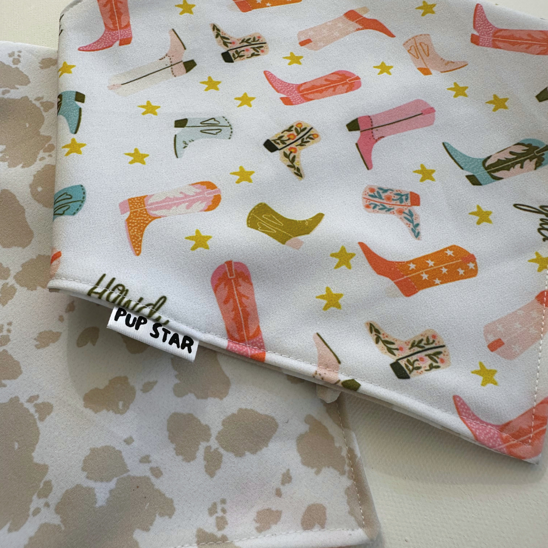 Reversible dog bandana with cowboy boots and cream cow print — waterproof, lightweight, and full of western charm.